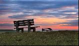 15: Two benches, a sunset and the sea.