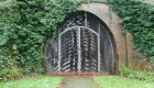 22: Gated railway tunnel entrance.