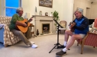 Chips and Chas play guitars in Tenby
