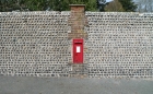 27: Georgian Post Box in an impressive brick and pebble wall.