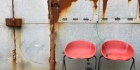 Two red chairs and a green bungee cord.